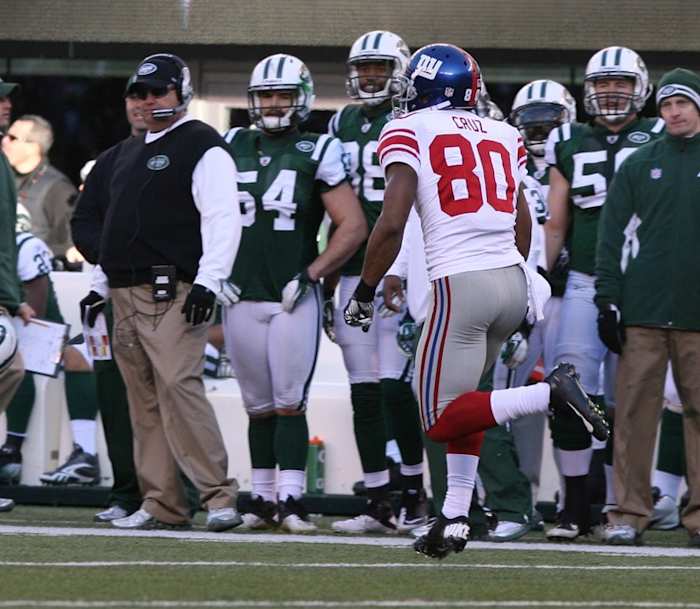 East Rutherford, New Jersey -- December 24, 2011 --- New York Giants vs New York Jets -- Victor Cruz runs past the Jets sideline as he scores a 99 yard touchdown pass in the first half.